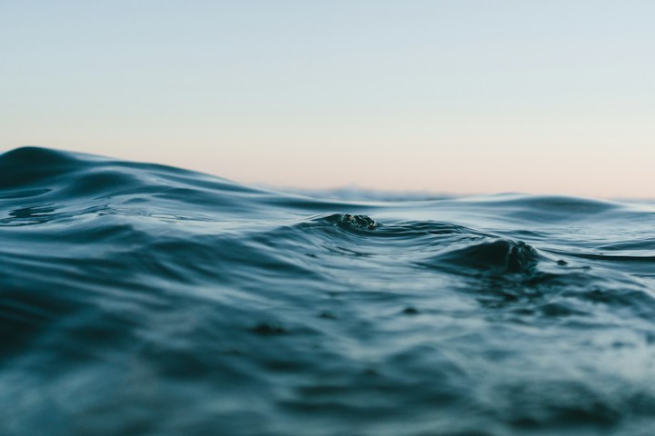 Sunlit ocean waves on an illustrative creator page